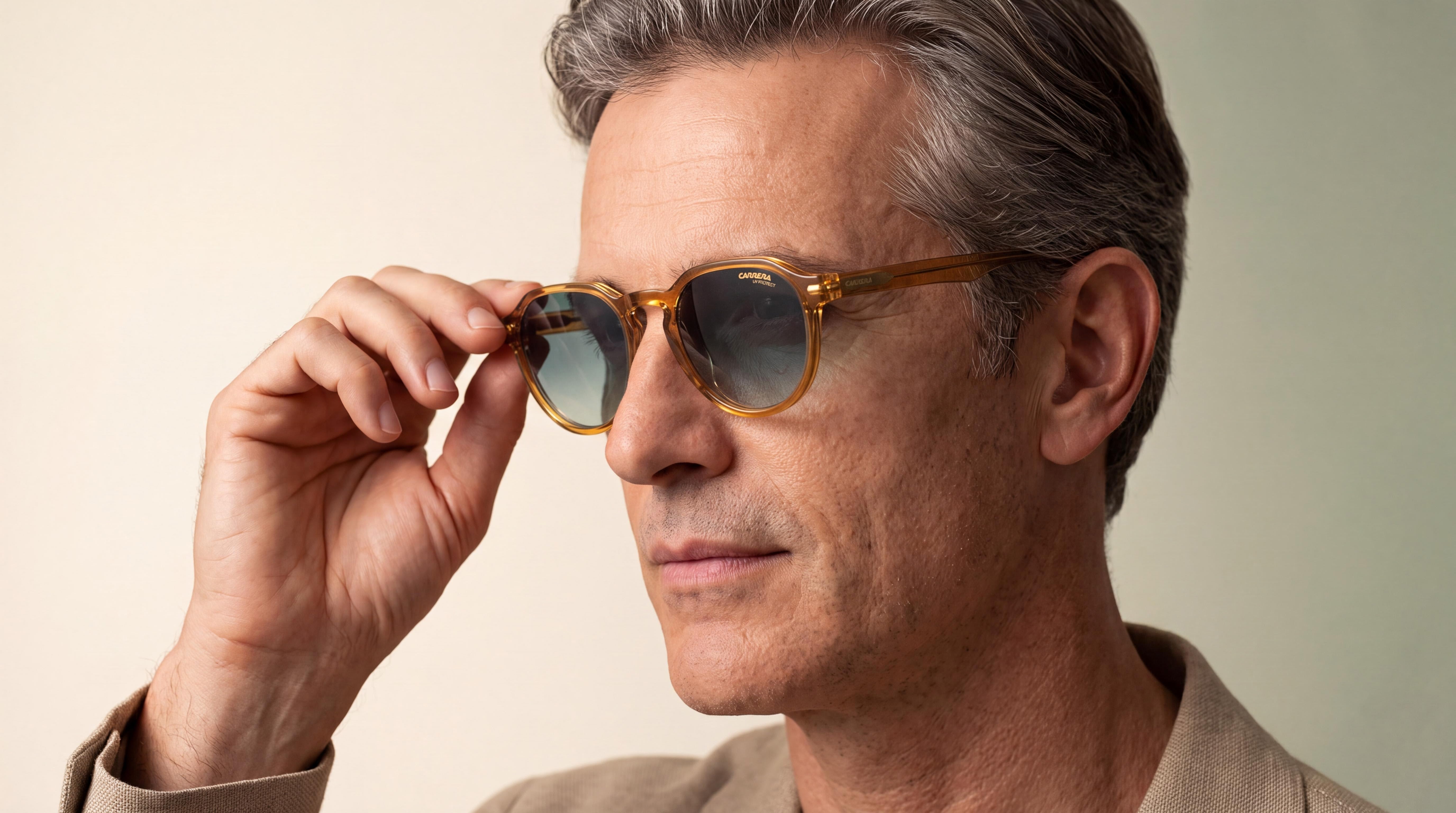 Elegant man adjusting his sunglasses, refined Mediterranean top, warm ivory and sage-green studio background, carrera sunglasses men