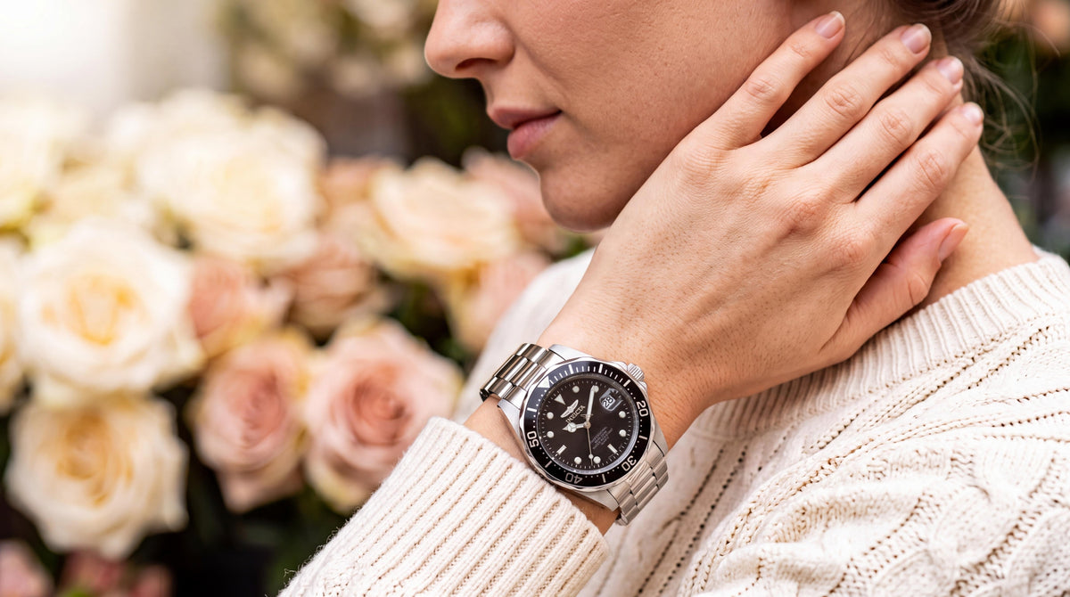 A refined woman in a cream sweater with her hand at her neck, featuring a black dial watch in a flower market. invicta black dial watches for women