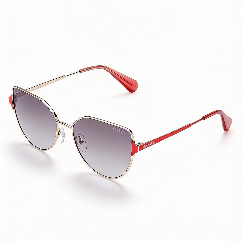 Gafas de sol modernas Max & Co. para mujer, montura de metal dorado con lentes de 57 mm no polarizadas con protección UV y efecto ahumado degradado.