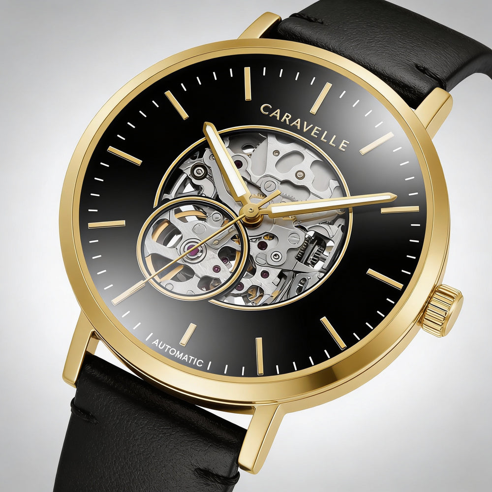 Reloj Caravelle clásico de vestir para hombre, automático, de acero inoxidable en tono dorado, con esqueleto y correa de piel negra.