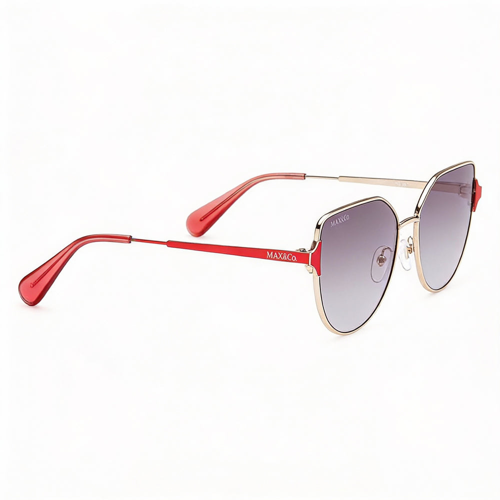 Gafas de sol modernas Max & Co. para mujer, montura de metal dorado con lentes de 57 mm no polarizadas con protección UV y efecto ahumado degradado.