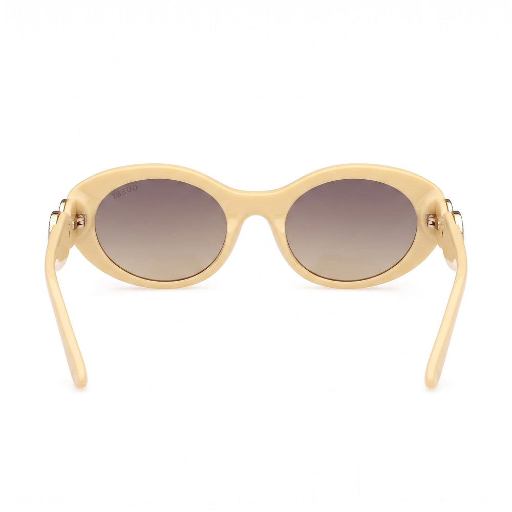GUESS Women's Oval Peony Plastic Sunglasses, Shiny Light Yellow Frame, Gradient Smoke Lenses, Non-Polarized, 100% UV Protection, 53mm