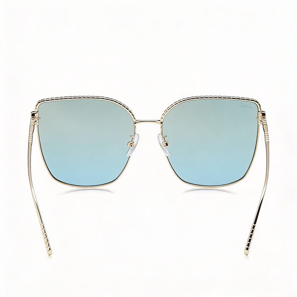 Gafas de sol casuales Chopard para mujer de titanio y oro rosa con lentes azules espejadas con gradiente dorado y protección UV 63-17-135